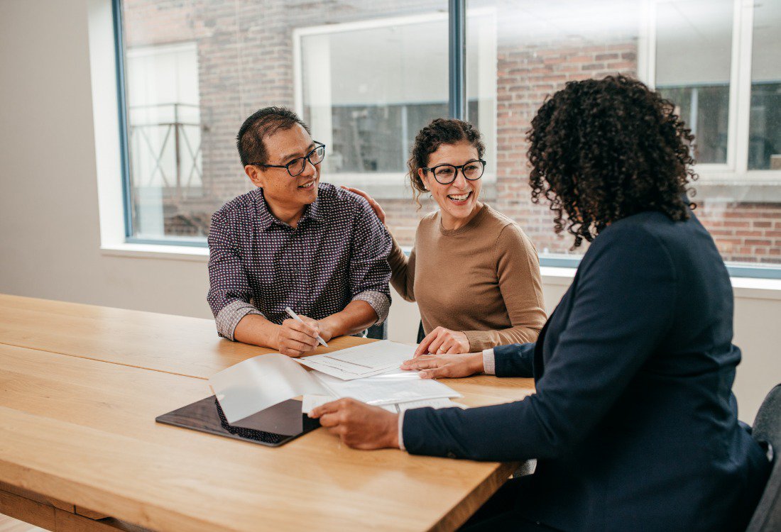 Portfolio landlords meeting with their professional property manager to discuss strategies for improving rental yields through expert property management.