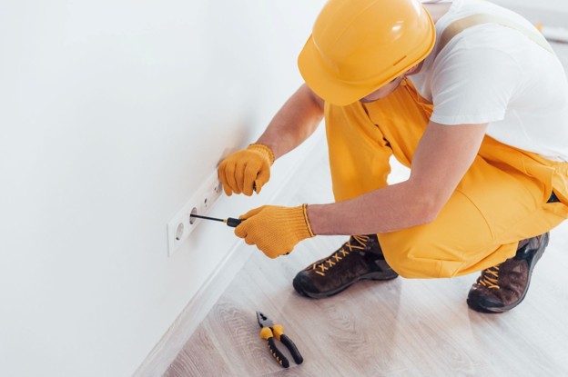 Contractor carrying out a small electrical repair in a Buy-To-Let property.