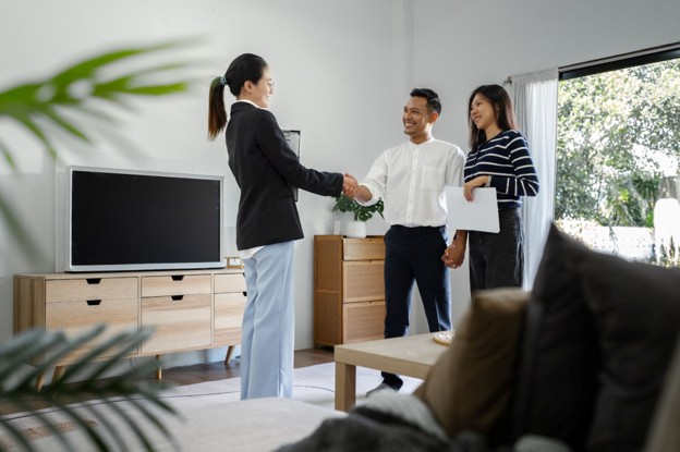 Letting Agents meeting with tenants in a home to discuss property management and rental arrangements.